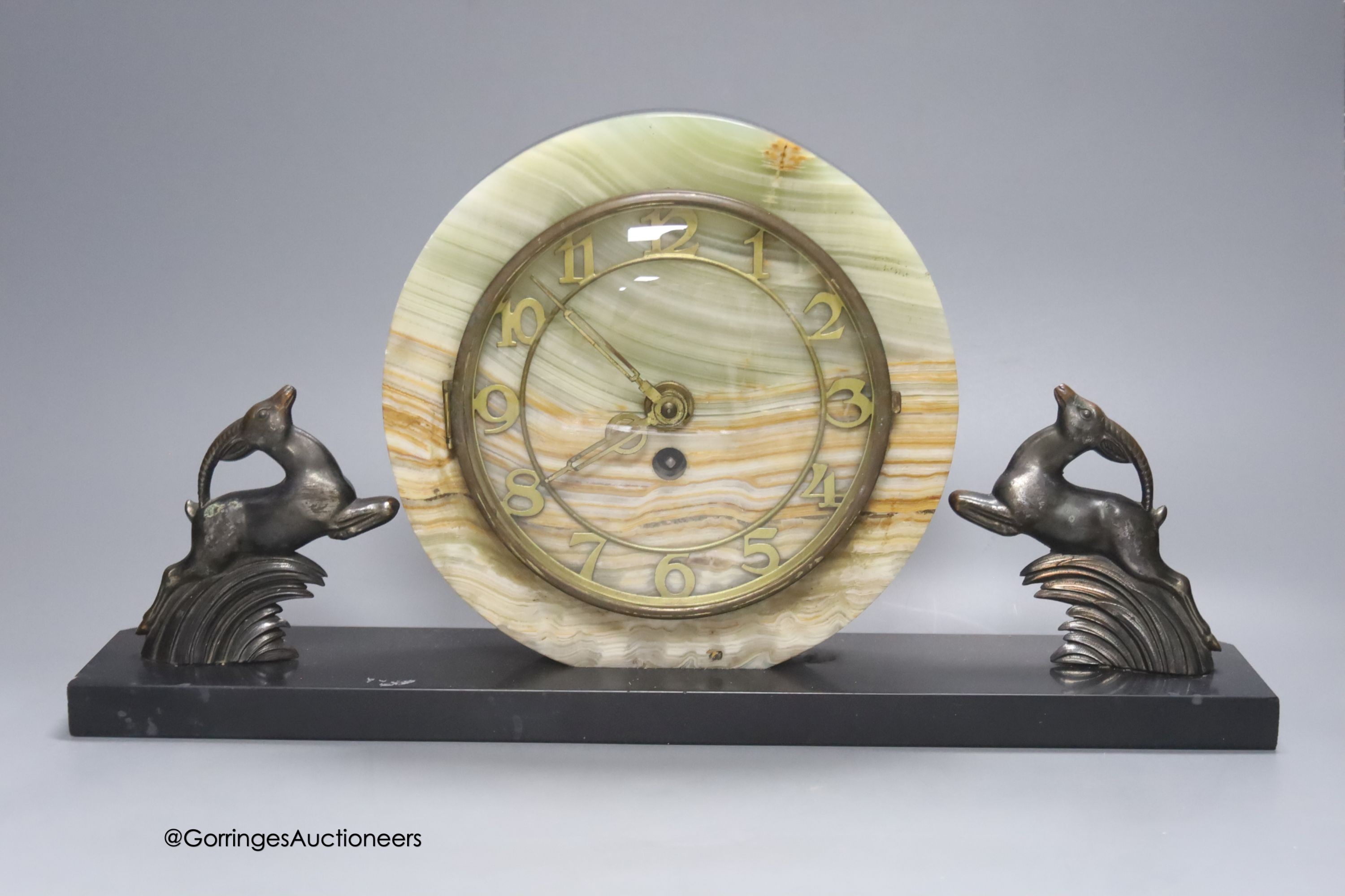 An Art Deco slate and onyx 'antelope' clock garniture, length of central piece 44cm